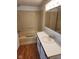 Bathroom with a tub-shower, vanity with sink, and tiled backsplash at 10129 Peartree Rd, Indianapolis, IN 46235