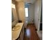 Bathroom featuring a vanity with sink, toilet, and convenient storage at 10129 Peartree Rd, Indianapolis, IN 46235
