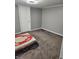 A simple bedroom with neutral gray walls and carpet at 10129 Peartree Rd, Indianapolis, IN 46235
