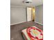 A large bedroom space with neutral gray walls and carpet at 10129 Peartree Rd, Indianapolis, IN 46235