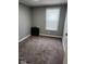 Bedroom with plush carpeting and a window providing ample natural light at 10129 Peartree Rd, Indianapolis, IN 46235
