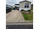 This property features a concrete driveway, covered porch, well-manicured lawn, and tidy landscaping at 10129 Peartree Rd, Indianapolis, IN 46235