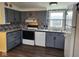 This kitchen features gray cabinets, black appliances, and decorative tile backsplash at 10129 Peartree Rd, Indianapolis, IN 46235