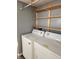 Practical laundry room with essential appliances and simple shelving for storage at 10129 Peartree Rd, Indianapolis, IN 46235