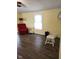 Bright living room features warm walls, vinyl floor, and a comfortable red armchair at 10129 Peartree Rd, Indianapolis, IN 46235