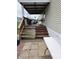 A covered porch with stairs, outdoor seating, and a partially painted steps at 10129 Peartree Rd, Indianapolis, IN 46235