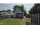 Home exterior with a small yard, fencing, and a covered porch at 1018 Jefferson Ave, Indianapolis, IN 46201