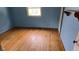 Bright bedroom with hardwood floors and soft blue walls, complemented by natural light at 1018 Jefferson Ave, Indianapolis, IN 46201