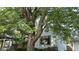 Charming home exterior with a large tree providing shade, enhancing curb appeal at 1018 Jefferson Ave, Indianapolis, IN 46201