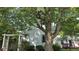 Charming home exterior with a large tree providing shade at 1018 Jefferson Ave, Indianapolis, IN 46201