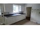 Traditional kitchen with white cabinets, modern sink, and view to the backyard at 1018 Jefferson Ave, Indianapolis, IN 46201