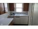 Compact kitchen featuring retro white appliances and a bright window view at 1018 Jefferson Ave, Indianapolis, IN 46201