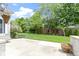 Backyard patio with a mix of greenery, privacy trees and partial fencing at 1051 Arrowwood Dr, Carmel, IN 46033