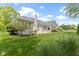Expansive backyard featuring lush greenery, well-maintained lawn, mature trees and patio space at 1051 Arrowwood Dr, Carmel, IN 46033
