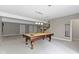 Basement rec room features a billiard table, and access to stairs at 1051 Arrowwood Dr, Carmel, IN 46033