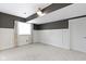 Cozy carpeted basement room with white wainscoting and a window at 1051 Arrowwood Dr, Carmel, IN 46033
