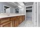 Bathroom with a double sink vanity, ample lighting, and tiled floors at 1051 Arrowwood Dr, Carmel, IN 46033