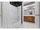Bathroom features a shower-tub combo with white tile and a wood vanity at 1051 Arrowwood Dr, Carmel, IN 46033