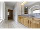 Bathroom with double vanity, tile floors, large mirror, and soaking tub at 1051 Arrowwood Dr, Carmel, IN 46033