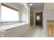 Bathroom featuring a soaking tub, tile floors, vanity, and glass shower at 1051 Arrowwood Dr, Carmel, IN 46033