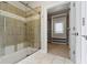 Bathroom featuring a tiled shower with a bench and a walk-in closet with built-in shelving at 1051 Arrowwood Dr, Carmel, IN 46033