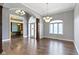 Open entryway with beautiful hardwood floors, arched doorways, and modern lighting at 1051 Arrowwood Dr, Carmel, IN 46033
