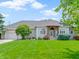 Charming single-story home with a manicured lawn, beautiful landscaping and inviting entrance at 1051 Arrowwood Dr, Carmel, IN 46033