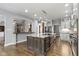 Modern kitchen with center island, granite countertops, stainless steel appliances, and open layout at 1051 Arrowwood Dr, Carmel, IN 46033