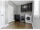 Well-equipped laundry room with modern appliances and ample cabinet space at 1051 Arrowwood Dr, Carmel, IN 46033