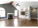 Bright living room featuring hardwood floors, fireplace, built-in shelves, and arched windows at 1051 Arrowwood Dr, Carmel, IN 46033
