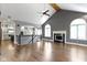 Open concept living room features hardwood floors, vaulted ceiling, and a cozy fireplace at 1051 Arrowwood Dr, Carmel, IN 46033