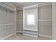 Walk-in closet featuring built-in shelving, carpeted floor, and a window at 1051 Arrowwood Dr, Carmel, IN 46033