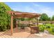 Backyard deck with a pergola, seating, and the pool is visible in the background at 1120 Mill Run Overlook, Noblesville, IN 46062