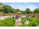 Backyard with a pool, lounge chairs, umbrella, and wood fence for privacy at 1120 Mill Run Overlook, Noblesville, IN 46062