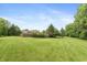 Large, grassy backyard bordered by mature trees and a wooden fence ensures privacy at 1120 Mill Run Overlook, Noblesville, IN 46062