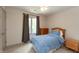 Bedroom with light carpet, ceiling fan, and a blue comforter set on a twin bed at 1120 Mill Run Overlook, Noblesville, IN 46062