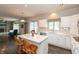 Bright kitchen featuring white cabinets, a center island, and hardwood flooring at 1120 Mill Run Overlook, Noblesville, IN 46062