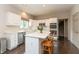 A well-lit kitchen with white cabinets, stainless steel appliances, and a center island at 1120 Mill Run Overlook, Noblesville, IN 46062