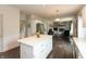 Open concept kitchen with island seating flows into a living room with a fireplace at 1120 Mill Run Overlook, Noblesville, IN 46062