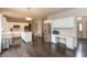 A spacious kitchen with white cabinets, stainless steel appliances, and an island with seating at 1120 Mill Run Overlook, Noblesville, IN 46062