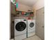 Functional laundry room with modern washer and dryer, shelving and convenient storage solutions at 1120 Mill Run Overlook, Noblesville, IN 46062