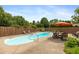 Backyard pool with lounge chairs, umbrella, and a table and chairs nearby at 1120 Mill Run Overlook, Noblesville, IN 46062
