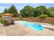 Backyard pool with chairs, an umbrella, and a diving board in a fenced yard at 1120 Mill Run Overlook, Noblesville, IN 46062