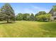 Expansive front yard with manicured lawn and mature trees offers great curb appeal at 1120 Mill Run Overlook, Noblesville, IN 46062