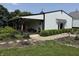 Exterior of large white barn featuring covered porch and lush landscaping at 115 W State Road 38, Pendleton, IN 46064