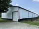 Large white barn with black trim, featuring a white garage door at 115 W State Road 38, Pendleton, IN 46064