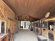 Interior of barn featuring multiple horse stalls and chandelier at 115 W State Road 38, Pendleton, IN 46064