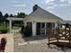 Exterior view of outdoor entertaining area with sliding glass doors and stone landscape at 115 W State Road 38, Pendleton, IN 46064