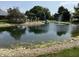 Scenic pond with a pergola, clubhouse, trees, and fountain under a sunny sky at 115 W State Road 38, Pendleton, IN 46064