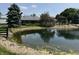 Scenic pond reflecting the clubhouse, trees, and pergola under a sunny sky at 115 W State Road 38, Pendleton, IN 46064